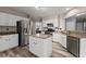 Spacious kitchen with stainless steel appliances, granite countertops, island, and white cabinets for a modern look at 1340 Gran Forest Dr, Cumming, GA 30041