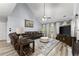 Comfortable living room featuring a leather sectional sofa, ceiling fan, and stylish area rug at 1340 Gran Forest Dr, Cumming, GA 30041