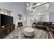 Bright living room with vaulted ceiling, a fireplace, hardwood floors, and comfortable leather seating at 1340 Gran Forest Dr, Cumming, GA 30041