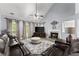 Spacious living room with a fireplace, vaulted ceilings, a ceiling fan, and comfortable leather seating at 1340 Gran Forest Dr, Cumming, GA 30041