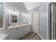 Well-lit bathroom boasts double sinks, modern vanity with marble top, and updated fixtures at 1340 Gran Forest Dr, Cumming, GA 30041