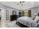 Spacious main bedroom with tray ceilings, ceiling fan, bedside tables, and a large window at 1340 Gran Forest Dr, Cumming, GA 30041
