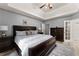 Charming main bedroom with tray ceilings, bedside lamps, and neutral colored walls at 1340 Gran Forest Dr, Cumming, GA 30041
