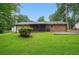 Expansive backyard featuring a screened-in porch and a well-maintained lawn surrounded by mature trees at 1960 Oak Leaf Sw Ct, Marietta, GA 30008