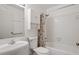 This is a bathroom with a shower/tub combo, toilet, and sink with white tiling at 1960 Oak Leaf Sw Ct, Marietta, GA 30008