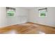 This bedroom features hardwood floors, two windows, and freshly painted walls at 1960 Oak Leaf Sw Ct, Marietta, GA 30008