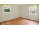 This bedroom features hardwood floors, two windows, and freshly painted walls at 1960 Oak Leaf Sw Ct, Marietta, GA 30008