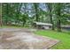 Spacious carport and driveway surrounded by lush trees providing shade and privacy at 1960 Oak Leaf Sw Ct, Marietta, GA 30008