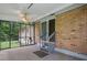 This is a screened patio with a ceiling fan and steps leading to the backyard at 1960 Oak Leaf Sw Ct, Marietta, GA 30008
