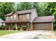 Attractive two-story home with a welcoming front porch, two-car garage, and ample parking space at 4424 English Loop, Stonecrest, GA 30038