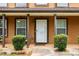 Inviting front porch with manicured bushes and a clear view of the home's entrance at 4424 English Loop, Stonecrest, GA 30038