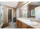 Bright main bathroom with double sinks, large mirror, walk-in shower and soaking tub at 4424 English Loop, Stonecrest, GA 30038