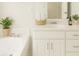 Bright bathroom featuring a soaking tub, white vanity with storage, and neutral finishes for a spa-like feel at 45 Avery Drive, Covington, GA 30016