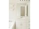 Bright bathroom featuring a white vanity, tub and ample lighting at 45 Avery Drive, Covington, GA 30016