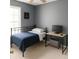 Simple bedroom with a metal bed frame, desk and a minimalist aesthetic at 45 Avery Drive, Covington, GA 30016