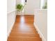 Inviting entryway with gleaming hardwood floors and a stylish plant accenting the bright, welcoming space at 45 Avery Drive, Covington, GA 30016