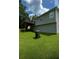 Home exterior with a spacious backyard, back deck, and well-maintained lawn at 45 Avery Drive, Covington, GA 30016