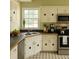 Well-lit kitchen with stainless steel appliances and classic black and white flooring at 45 Avery Drive, Covington, GA 30016