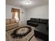 Cozy living room featuring a black sectional sofa and a patterned area rug at 45 Avery Drive, Covington, GA 30016