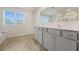 Bathroom featuring double vanity, large mirror, and window providing natural light at 826 Bentley Dr, Fairburn, GA 30213