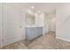 Double vanity sinks, large mirror, and wood-look floors add a luxury touch to the bathroom at 826 Bentley Dr, Fairburn, GA 30213