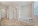 Well-lit bathroom with shower and soaking tub, complemented by tile flooring and modern fixtures at 826 Bentley Dr, Fairburn, GA 30213
