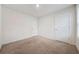 Bedroom featuring neutral carpeting and two white doors at 826 Bentley Dr, Fairburn, GA 30213