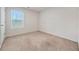 Bedroom with window, neutral carpeting, and white walls and trim at 826 Bentley Dr, Fairburn, GA 30213