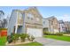 Attractive two-story home displaying a brick and stone facade, alongside an attached two-car garage at 826 Bentley Dr, Fairburn, GA 30213