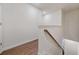 Hallway features wood floors, white walls, and wooden railing at 826 Bentley Dr, Fairburn, GA 30213