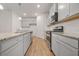 Modern kitchen featuring gray cabinets, granite countertops, and stainless steel appliances at 826 Bentley Dr, Fairburn, GA 30213
