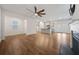 Expansive living space boasts hardwood flooring, fireplace, and modern open layout to kitchen at 826 Bentley Dr, Fairburn, GA 30213