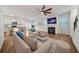 Open-concept living area with hardwood floors, fireplace, and adjacent modern kitchen at 826 Bentley Dr, Fairburn, GA 30213