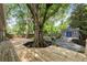 Expansive backyard with deck, fire pit area, shed, and a towering mature tree at 957 Sharon Se Cir, Smyrna, GA 30080