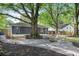 Backyard with mature trees, a stone fire pit area, seating, and a cozy atmosphere at 957 Sharon Se Cir, Smyrna, GA 30080