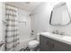 Well-lit bathroom featuring a subway tile shower, stylish vanity, and patterned floor tiles at 957 Sharon Se Cir, Smyrna, GA 30080
