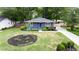Aerial view of the home's front yard showcasing landscaping, blue accents, and mature trees at 957 Sharon Se Cir, Smyrna, GA 30080
