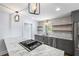 Kitchen island with marble countertop and gas stovetop with tile backsplash and floating shelves at 957 Sharon Se Cir, Smyrna, GA 30080