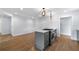 Kitchen island with gas stovetop and gray cabinets with hardwood flooring at 957 Sharon Se Cir, Smyrna, GA 30080