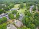 Aerial view of property near a golf course, lake, and lush landscaping at 6245 Hampton Golf Club Dr, Cumming, GA 30041