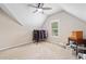 Attic space featuring slanted ceilings, a window, carpeted floors, and a clothing rack at 6245 Hampton Golf Club Dr, Cumming, GA 30041