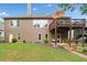Spacious backyard featuring a deck, patio, and well-maintained lawn at 6245 Hampton Golf Club Dr, Cumming, GA 30041