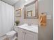 Bathroom with a vanity, framed mirror, toilet and shower at 6245 Hampton Golf Club Dr, Cumming, GA 30041