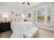 Inviting bedroom featuring light walls, large sunny windows, and dark wood furniture at 6245 Hampton Golf Club Dr, Cumming, GA 30041