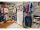 Walk-in closet with custom shelving, drawers, and ample hanging space for organized storage at 6245 Hampton Golf Club Dr, Cumming, GA 30041