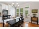 Dining room with a large table, chandelier, and natural light at 6245 Hampton Golf Club Dr, Cumming, GA 30041