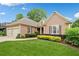 Charming one-story home featuring manicured lawn and beautiful landscaping at 6245 Hampton Golf Club Dr, Cumming, GA 30041