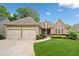 Charming one-story home featuring manicured lawn and two-car garage at 6245 Hampton Golf Club Dr, Cumming, GA 30041
