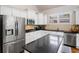 Updated kitchen featuring an island, granite countertops, and stainless steel appliances at 6245 Hampton Golf Club Dr, Cumming, GA 30041