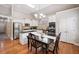 Spacious kitchen featuring a dining area, granite countertops, and stainless steel appliances at 6245 Hampton Golf Club Dr, Cumming, GA 30041